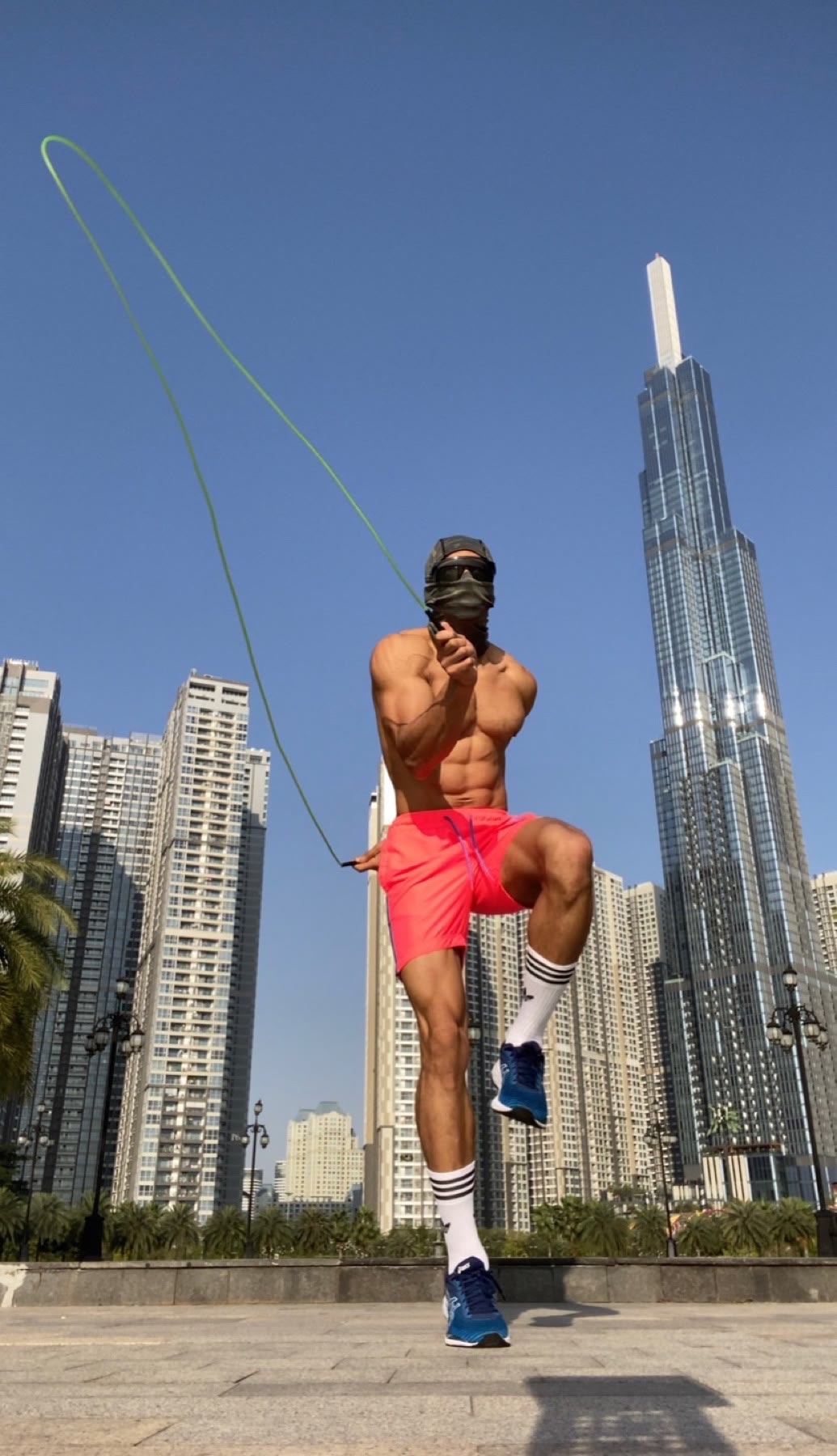 OYOTTA jumping rope against a bright city skyline